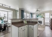 Thumbnail 4 of 14 - Kitchen with brown countertop at The Retreat at Fox Hollow apartments for rent in Lakewood, CO.