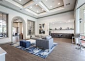 Thumbnail 8 of 14 - Living room with grey sofa and blue rug at The Retreat at Fox Hollow Lakewood, CO apartments.