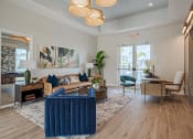Thumbnail 26 of 59 - a living room with blue furniture and a door to a balcony