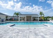 Thumbnail 31 of 59 - a large swimming pool with a house in the background