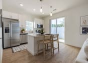 Thumbnail 10 of 59 - a kitchen with a center island and a stainless steel refrigerator