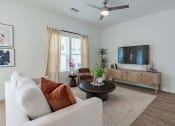 Thumbnail 17 of 59 - a living room with a couch and a tv