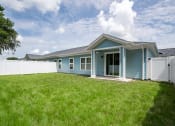Thumbnail 43 of 59 - a blue house with a yard and a white fence