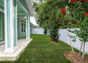 Thumbnail 15 of 59 - a yard in front of a house with a lawn and trees