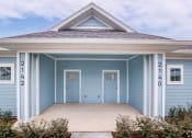 Thumbnail 5 of 59 - a blue house with two doors and a porch