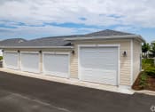 Thumbnail 58 of 59 - a row of three garage doors on the side of a house