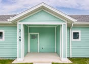 Thumbnail 9 of 59 - the front of a blue house with a front porch
