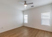 Thumbnail 54 of 59 - an empty room with hardwood floors and a ceiling fan