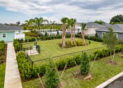 Thumbnail 13 of 59 - the view of a backyard with trees and a tennis court