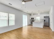 Thumbnail 53 of 59 - an empty living room and kitchen with white walls and wood floors