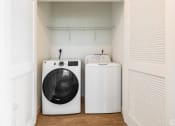Thumbnail 56 of 59 - a laundry room with a washing machine and a washer and dryer