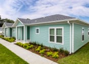 Thumbnail 7 of 59 - a row of blue houses with a sidewalk in front of them
