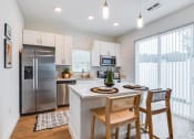 Thumbnail 4 of 59 - an open kitchen and dining area with stainless steel appliances and a large window
