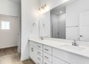Thumbnail 50 of 59 - a white bathroom with a large mirror and two sinks