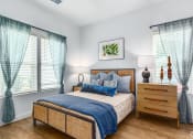 Thumbnail 19 of 59 - a bedroom with a bed and a dresser