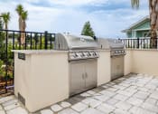 Thumbnail 14 of 59 - two stainless steel barbecue grills on a patio in front of a house