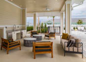 Thumbnail 34 of 59 - a living room with a kitchen and a patio