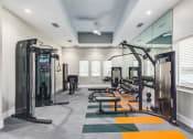 Thumbnail 11 of 59 - a gym with cardio equipment and mirrors in a building with white walls