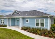 Thumbnail 3 of 59 - a blue house with a sidewalk in front of it