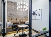 Thumbnail 21 of 24 - a living room with a couch and a table and a chandelier