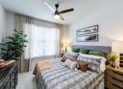 Thumbnail 15 of 24 - our apartments offer a spacious bedroom with a ceiling fan
