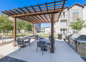 Thumbnail 17 of 24 - an outdoor patio with tables and chairs and a pergola
