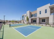 Thumbnail 6 of 59 - a tennis court with a building in the background at Element 12 Apartments, Henderson NV