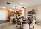 Thumbnail 27 of 32 - an open kitchen and dining room with a table and chairs