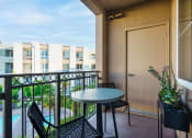Thumbnail 24 of 32 - a balcony with a table and chairs and a door