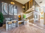Thumbnail 1 of 32 - a dining room with a table and stools in front of a large wall mural