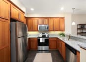 Thumbnail 28 of 32 - a kitchen with stainless steel appliances and granite counter tops