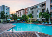 Thumbnail 15 of 32 - a swimming pool in front of an apartment building