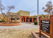 Thumbnail 1 of 13 - A sign in front of a building that says Estrada Pointe Apartments.