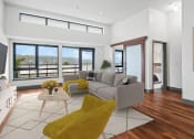 Thumbnail 5 of 51 - Living room with a gray couch and yellow chairs at Equinox, WA, 98102