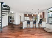 Thumbnail 9 of 51 - Living room with a kitchen and a staircase at Equinox, Seattle