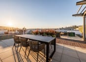 Thumbnail 30 of 51 - Equinox Rooftop Terrence dining table  at Equinox Apartments, Seattle, WA