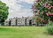 Thumbnail 36 of 39 - A large building with a green lawn in front of it.