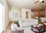 Thumbnail 17 of 60 - a living room filled with furniture and a ceiling fan