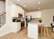 Thumbnail 14 of 60 - a kitchen with white cabinets and stainless steel appliances