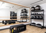 Thumbnail 34 of 34 - A gym with a mirror, weights, and exercise balls.