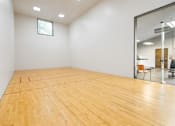 Thumbnail 26 of 39 - A room with wooden flooring and a glass wall.