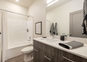 Thumbnail 11 of 29 - a bathroom with a sink and a shower and a toilet
