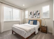 Thumbnail 18 of 29 - a bedroom with a bed and two windows