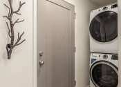 Thumbnail 21 of 29 - a small laundry room with a washing machine and a dryer
