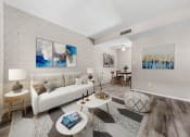Thumbnail 1 of 23 - a living room with a white couch and a table