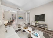 Thumbnail 2 of 23 - Living room with neutral decor, wall-mounted TV, and dining area access.