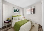 Thumbnail 4 of 23 - a bedroom with a bed and a green blanket