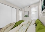 Thumbnail 5 of 23 - a bedroom with a large bed and green pillows