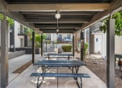 Thumbnail 19 of 23 - Covered outdoor picnic area with tables and seating.