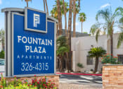 Thumbnail 23 of 23 - a sign for the fountain plaza apartments in front of a building